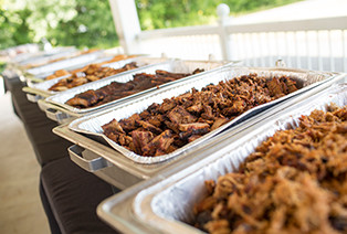 trays of Famous Dave's BBQ Meat at a catering event